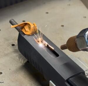 Pistol barrel and slide laser porting in progress